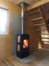 Популярный камин с дровницей Сибирь 8 в интерьере фото в Борисове