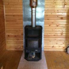 Печь-камин с шамотом Мета-Бел Ангара-Аква в интерьере фото в Борисове